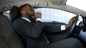 tired businessman at risk for drowsy driving crash